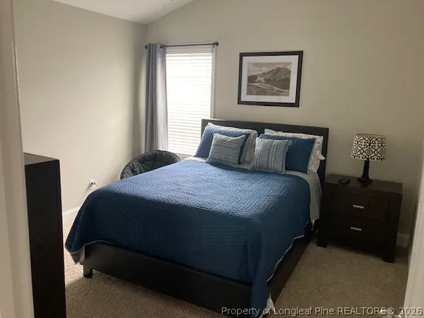 a bedroom with a bed and window