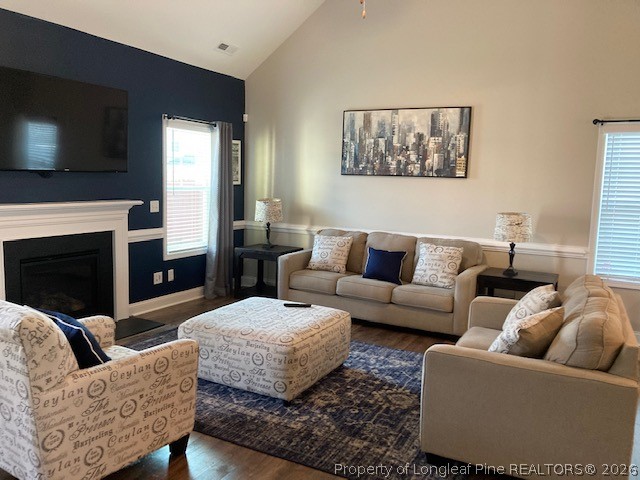 144 Haynes Church Road Raeford, NC 28376 - Photo 8 of 24 a living room with furniture a flat screen tv and a fireplace