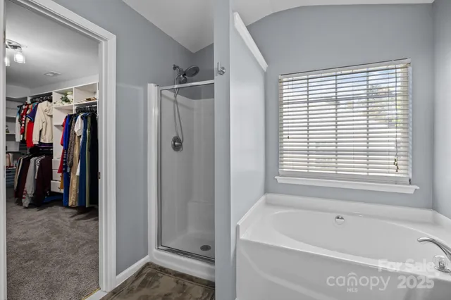 a bathroom with a bathtub and a shower