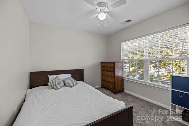 a bedroom with a large bed and a window