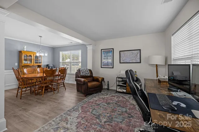 a living room with furniture a flat screen tv and a window