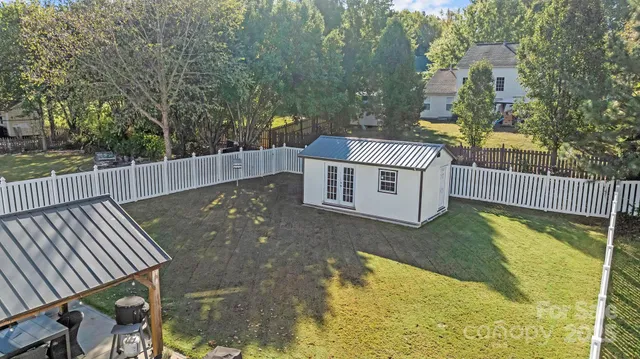 a view of a backyard with wooden fence