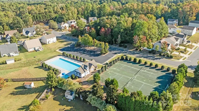 an aerial view of a house with a yard and lake view