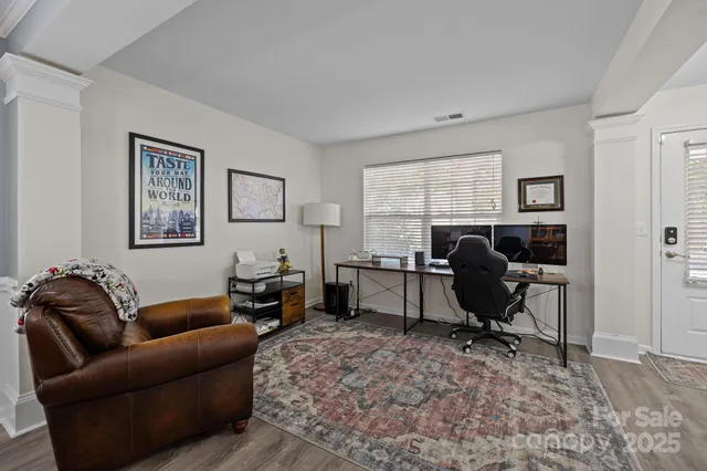 a view of a livingroom with workspace and a couch