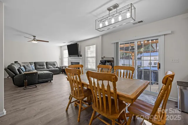 a living room with furniture a chandelier and a flat screen tv