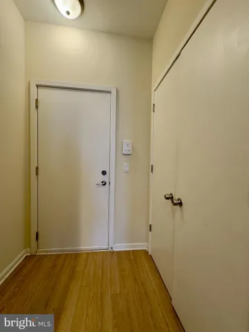 a view of an empty room with wooden floor