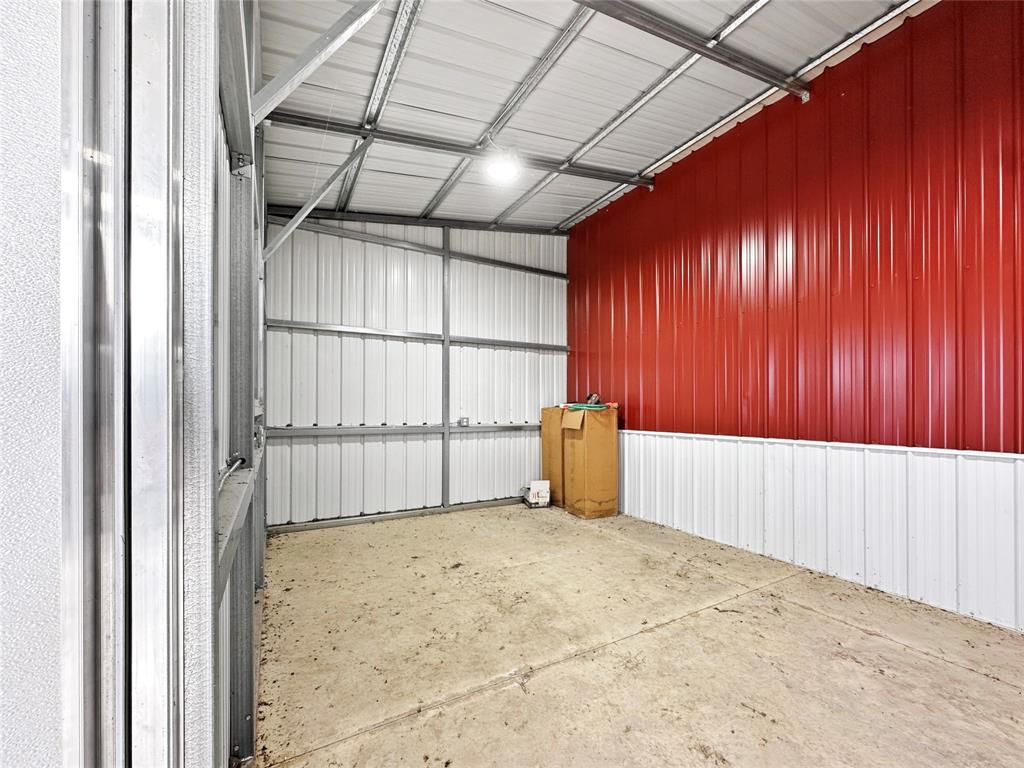 501 County Road 501 Blue Ridge, TX 75424 - Photo 12 of 27 Enclosed tack room with metal-paneled walls, concrete flooring, electrical access, and a secure door, suitable for organized equipment and supply storage.