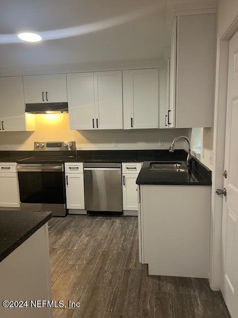 10322 State Rte 100 Starke, FL 32091 - Photo 11 of 15 a kitchen with stainless steel appliances granite countertop a stove a sink and white cabinets