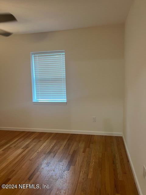 10322 State Rte 100 Starke, FL 32091 - Photo 14 of 15 an empty room with wooden floor and windows