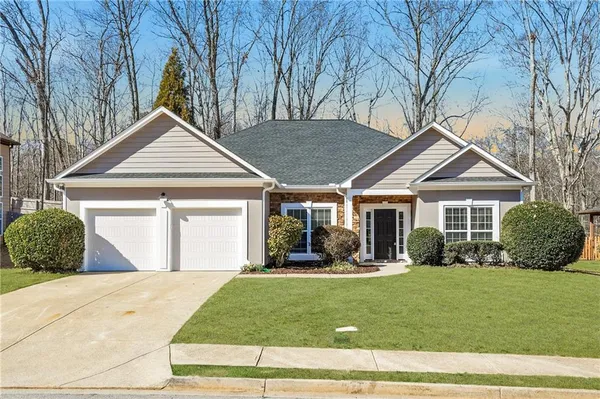 a front view of a house with a yard