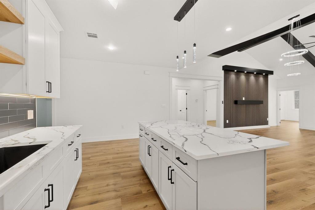 6039 Plum Dale Road Dallas, TX 75241 - Photo 10 of 38 a large white kitchen with a sink and a refrigerator