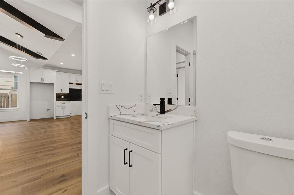 6039 Plum Dale Road Dallas, TX 75241 - Photo 12 of 38 a view of a bathroom with a sink and mirror