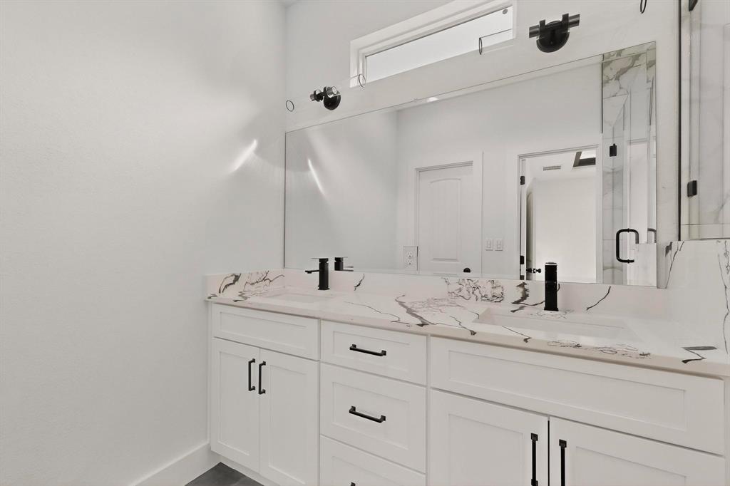 6039 Plum Dale Road Dallas, TX 75241 - Photo 17 of 38 a bathroom with a double vanity sink and mirror