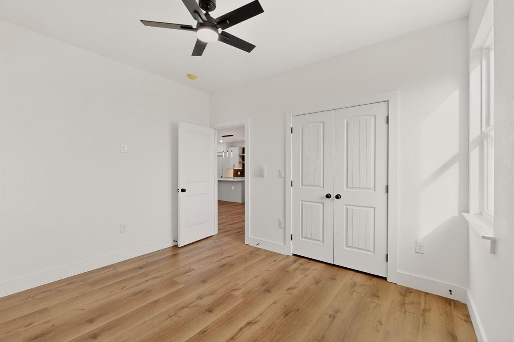 6039 Plum Dale Road Dallas, TX 75241 - Photo 21 of 38 a view of a room with wooden floor and white walls