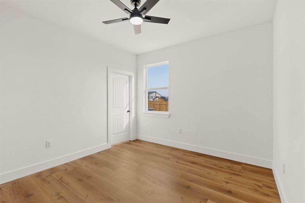 6039 Plum Dale Road Dallas, TX 75241 - Photo 22 of 38 an empty room with a window and a ceiling fan
