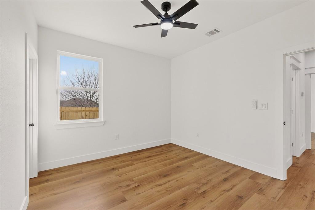 6039 Plum Dale Road Dallas, TX 75241 - Photo 23 of 38 an empty room with a window and a ceiling fan
