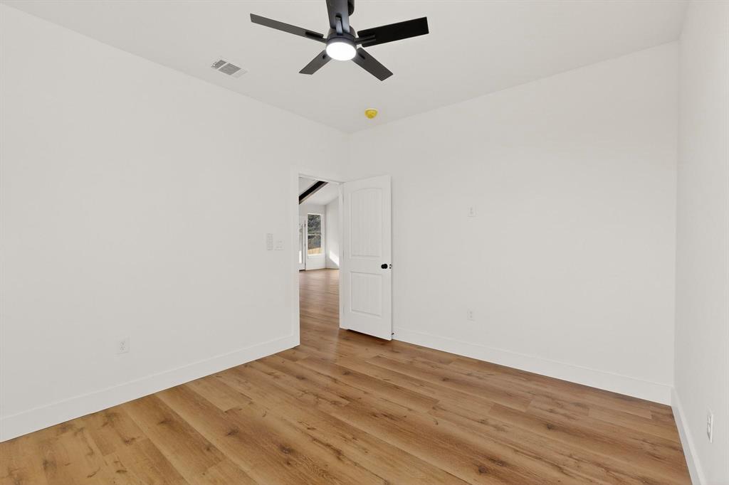 6039 Plum Dale Road Dallas, TX 75241 - Photo 24 of 38 a view of empty room with wooden floor