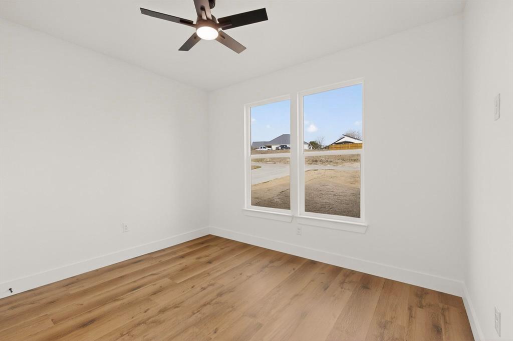 6039 Plum Dale Road Dallas, TX 75241 - Photo 25 of 38 a view of a room with a window and hardwood floor