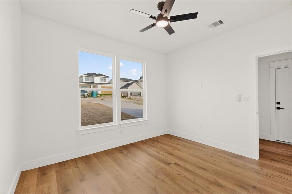 6039 Plum Dale Road Dallas, TX 75241 - Photo 26 of 38 a view of empty room with wooden floor and fan
