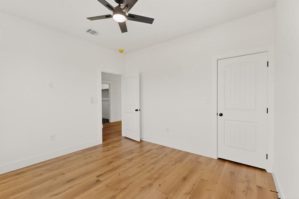 6039 Plum Dale Road Dallas, TX 75241 - Photo 27 of 38 a view of an empty room with wooden floor