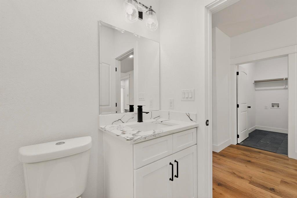 6039 Plum Dale Road Dallas, TX 75241 - Photo 29 of 38 a bathroom with a sink and a toilet