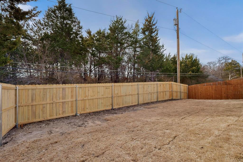 6039 Plum Dale Road Dallas, TX 75241 - Photo 37 of 38 a view of backyard and tree