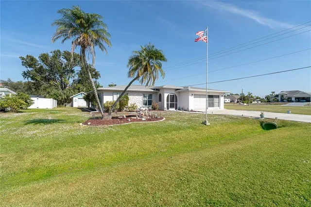 a front view of house with yard and swimming pool