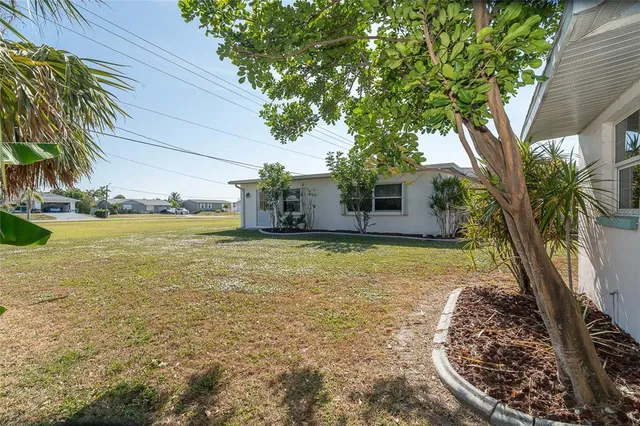 a view of a house with a yard and garage