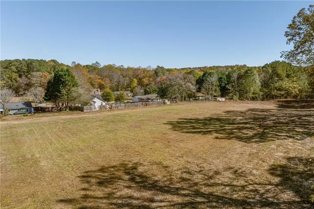 a view of dirt field with trees