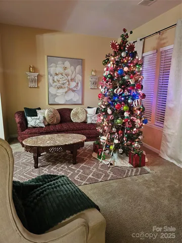 a living room with furniture and flowers