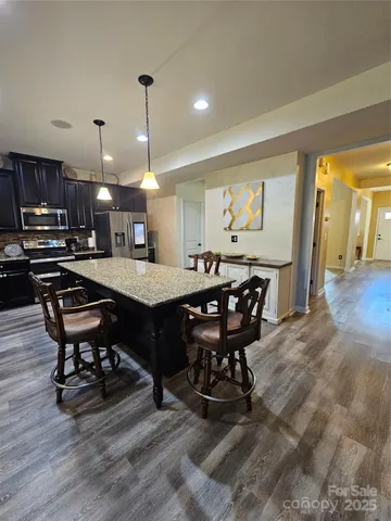 a kitchen with a table and chairs in it
