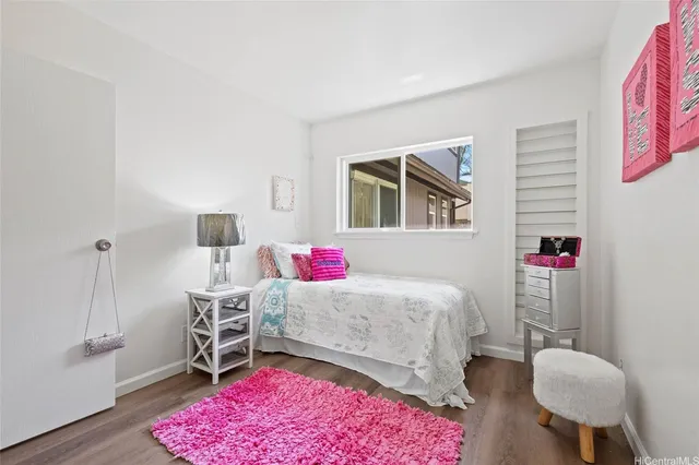 a bedroom with a bed dresser and a window