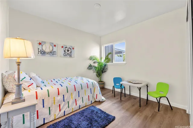 a bedroom that has a bed and a chair in it