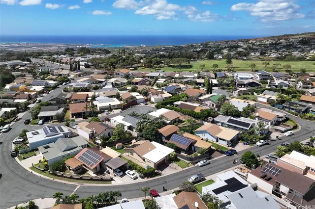 an aerial view of residential houses with city view