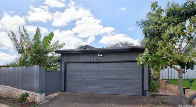 a front view of a house with a garden