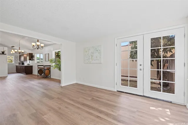 a view of a livingroom with furniture and an empty room