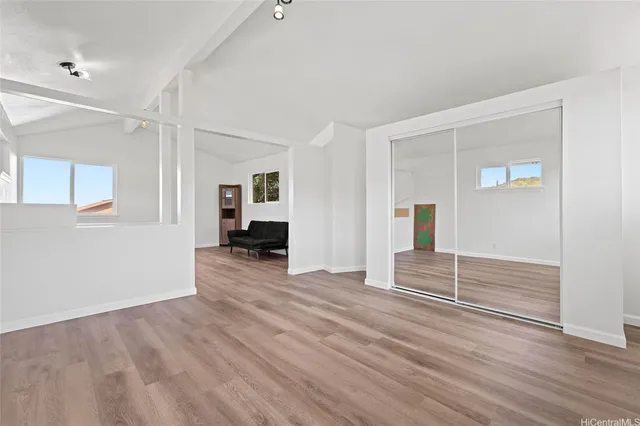 wooden floor with white walls and windows