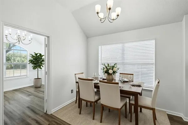 a view of a dining room with furniture window and wooden floor