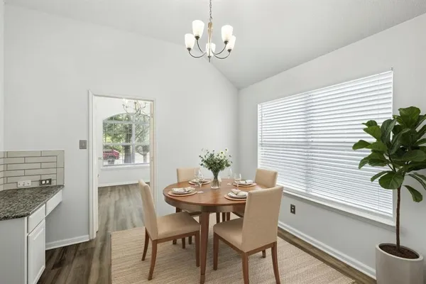 a view of a dining room with furniture window and wooden floor