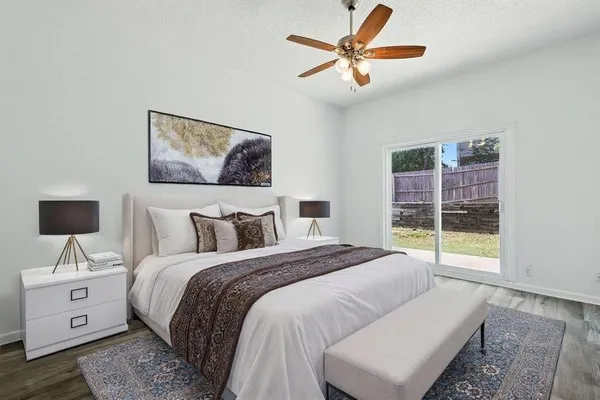 a bedroom with a large bed and a window