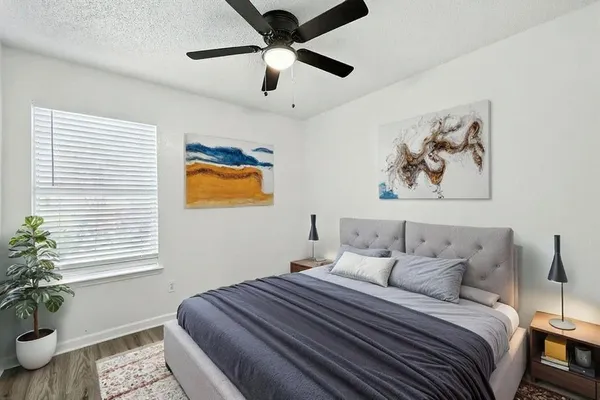 a bedroom with bed and a window