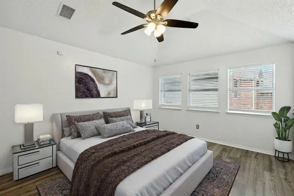 a bedroom with a large bed and a window