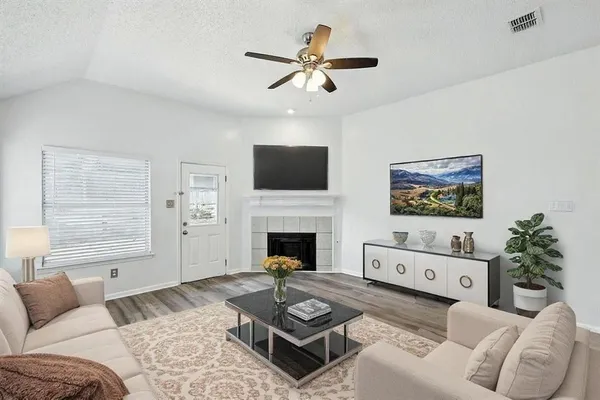 a living room with furniture a window and a fireplace