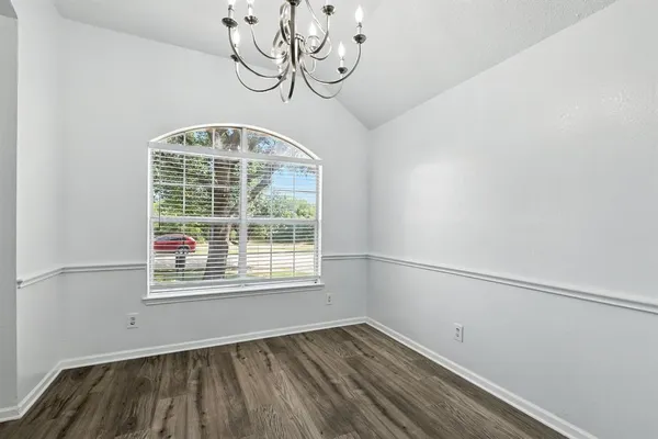 a view of a room with rack on the wall and a window