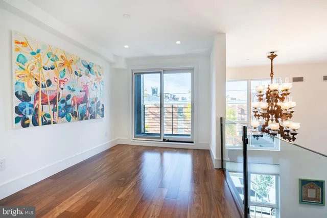 a view of a room with furniture and wooden floor