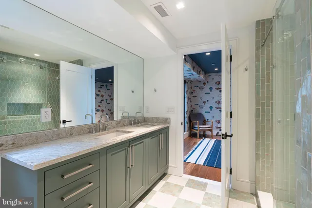 a bathroom with a sink a mirror and a shower