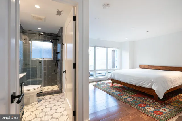 a bedroom with a bed and glass door