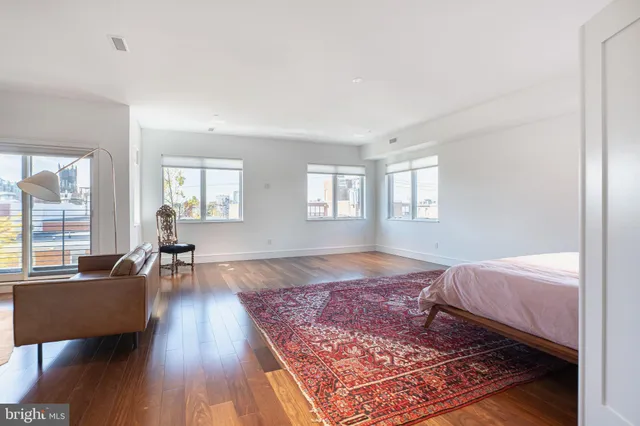a bed room with a bed and wooden floor