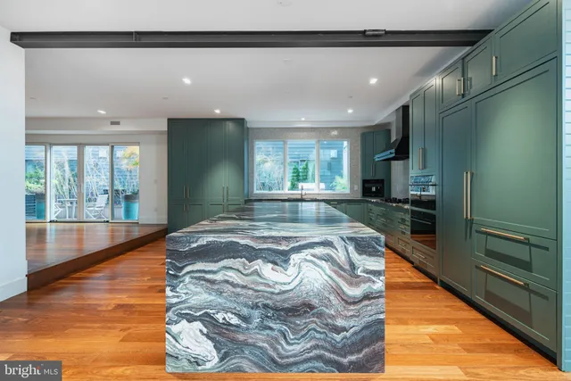 a large kitchen with kitchen island granite countertop a large window