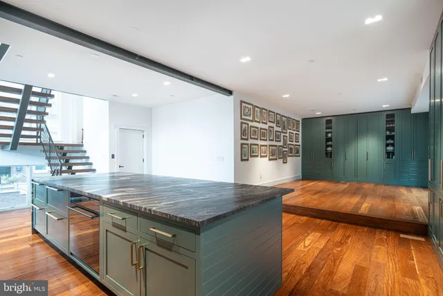 a kitchen with stainless steel appliances granite countertop a sink and a refrigerator